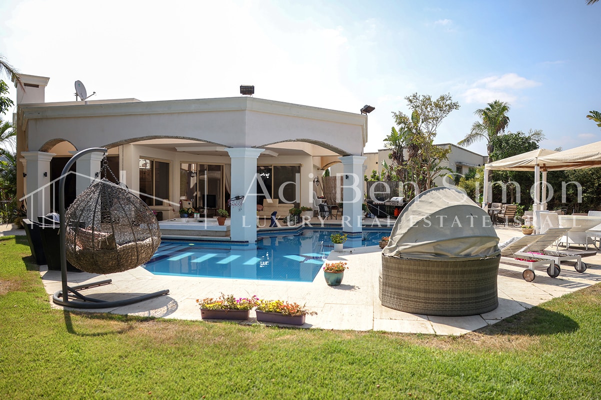 בריכה גדולה וגקוזי מבעבע שטח הגינה גובל בשצפ ירוק וגדול